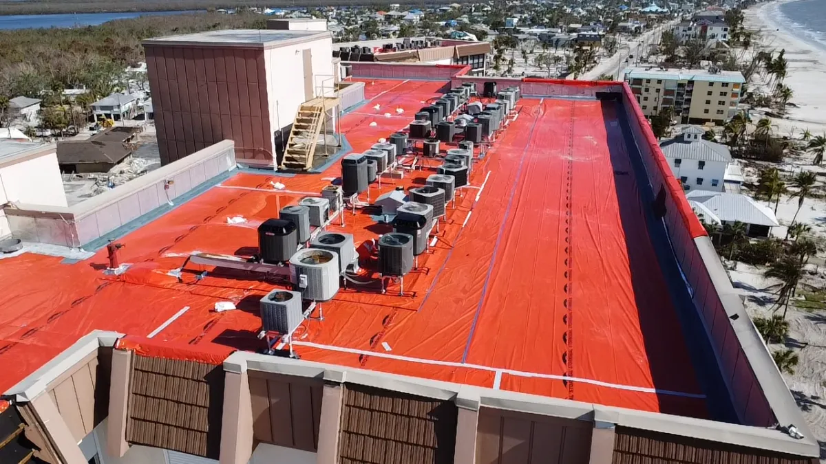 Orange tarp on commercial high-rise rooftop