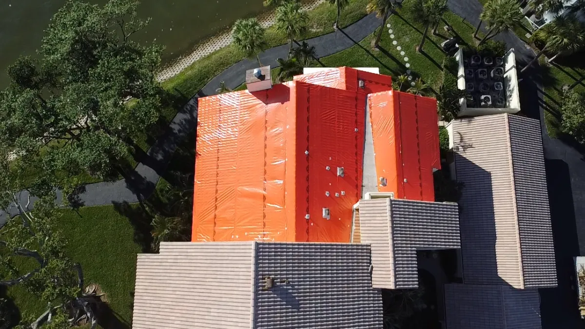 Emergency roof tarping on lakeside building